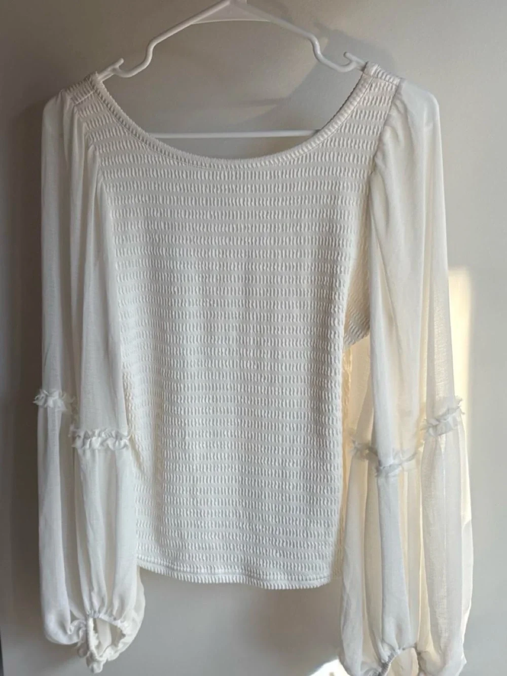 White flowy long sleeve top with ruffle detail